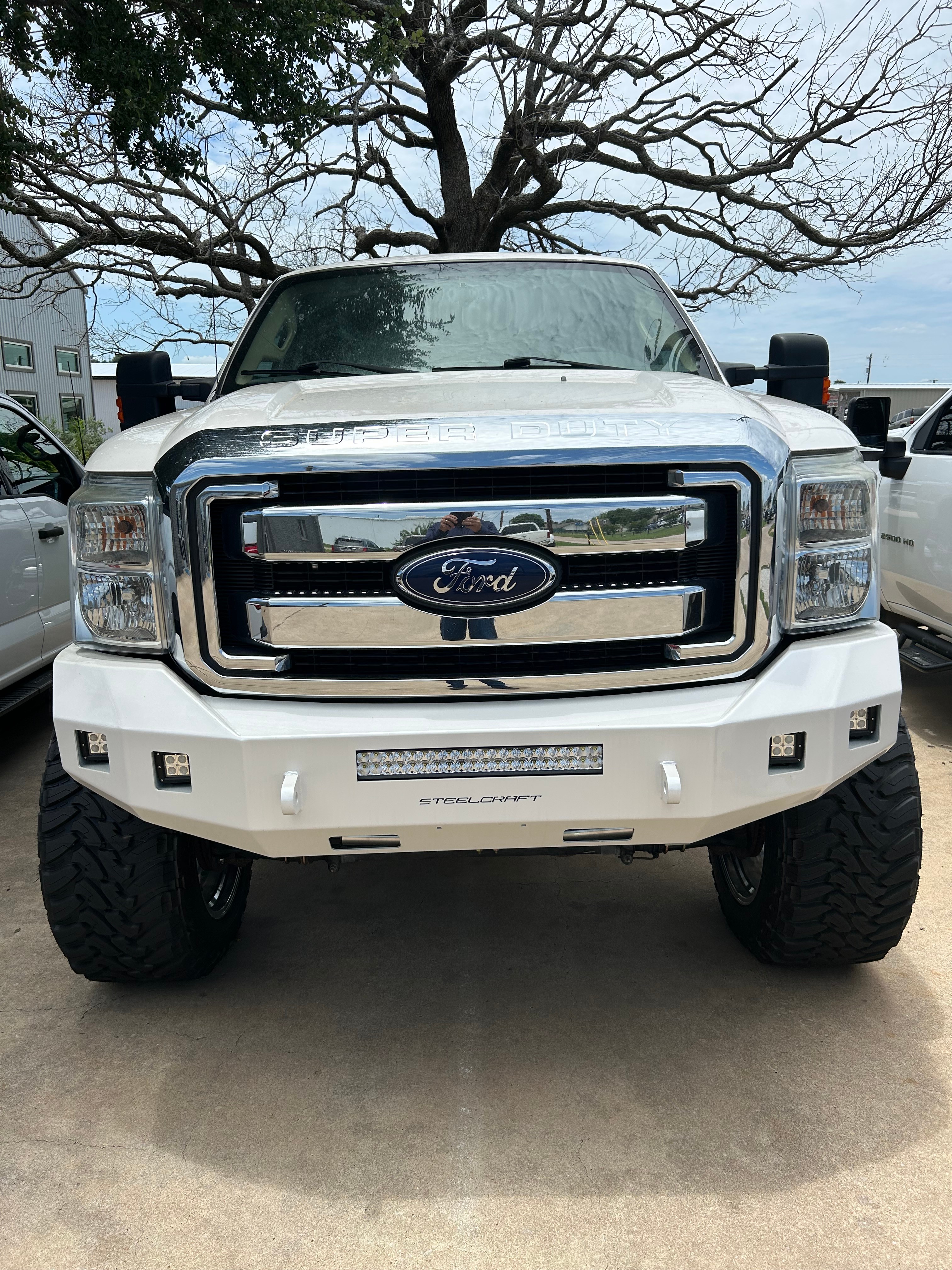 Lifted Ford F-250 Super Duty with Steelcraft front bumper, LED light bar, and lifted suspension — Truck Country Outfitters, Marble Falls TX